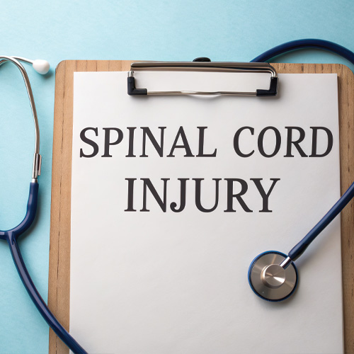 clipboard with a piece of paper that reads "spinal cord injury"
